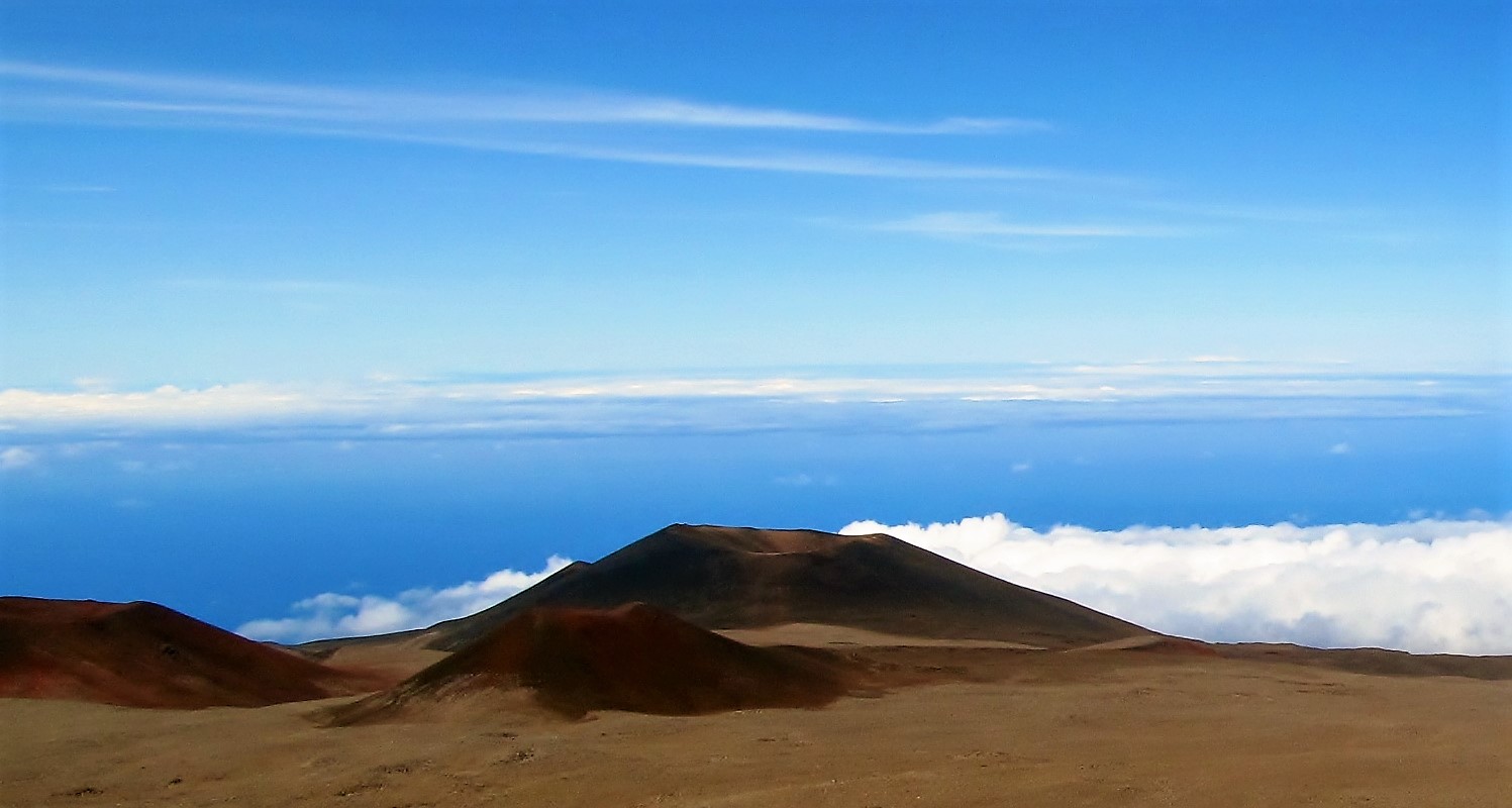 Hawaiian volcanoes rise above the ocean