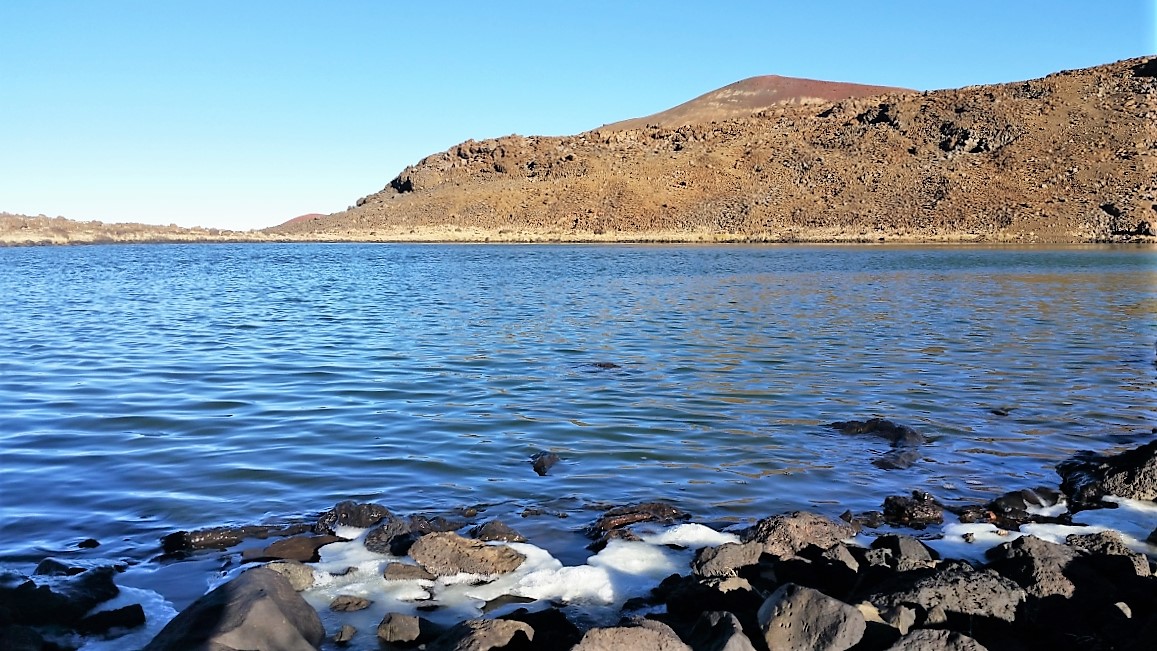 Ice forms along Waiau's shoreline in the cold air of Mauna Kea