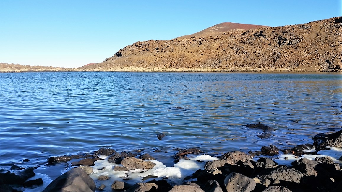 Ice forms along Waiau's shoreline in the cold air of Mauna Kea