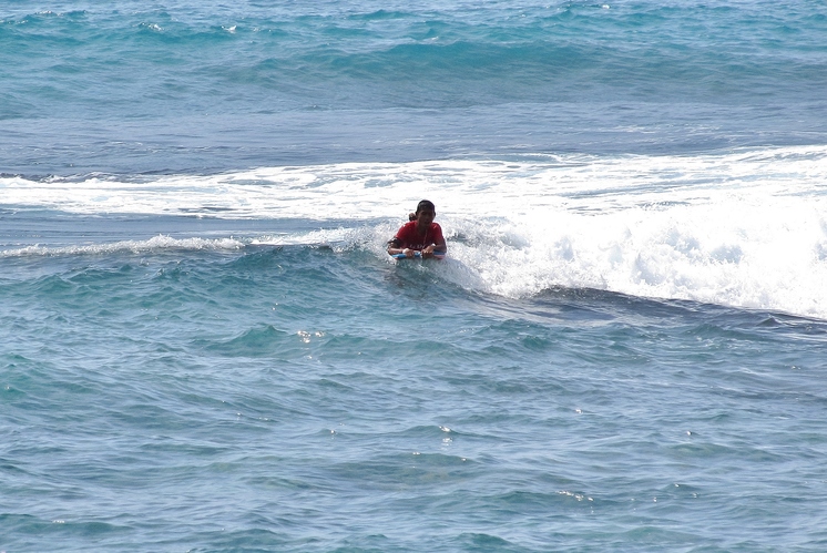 Boogie boarding Wai'aha Bay at Honl's Beach